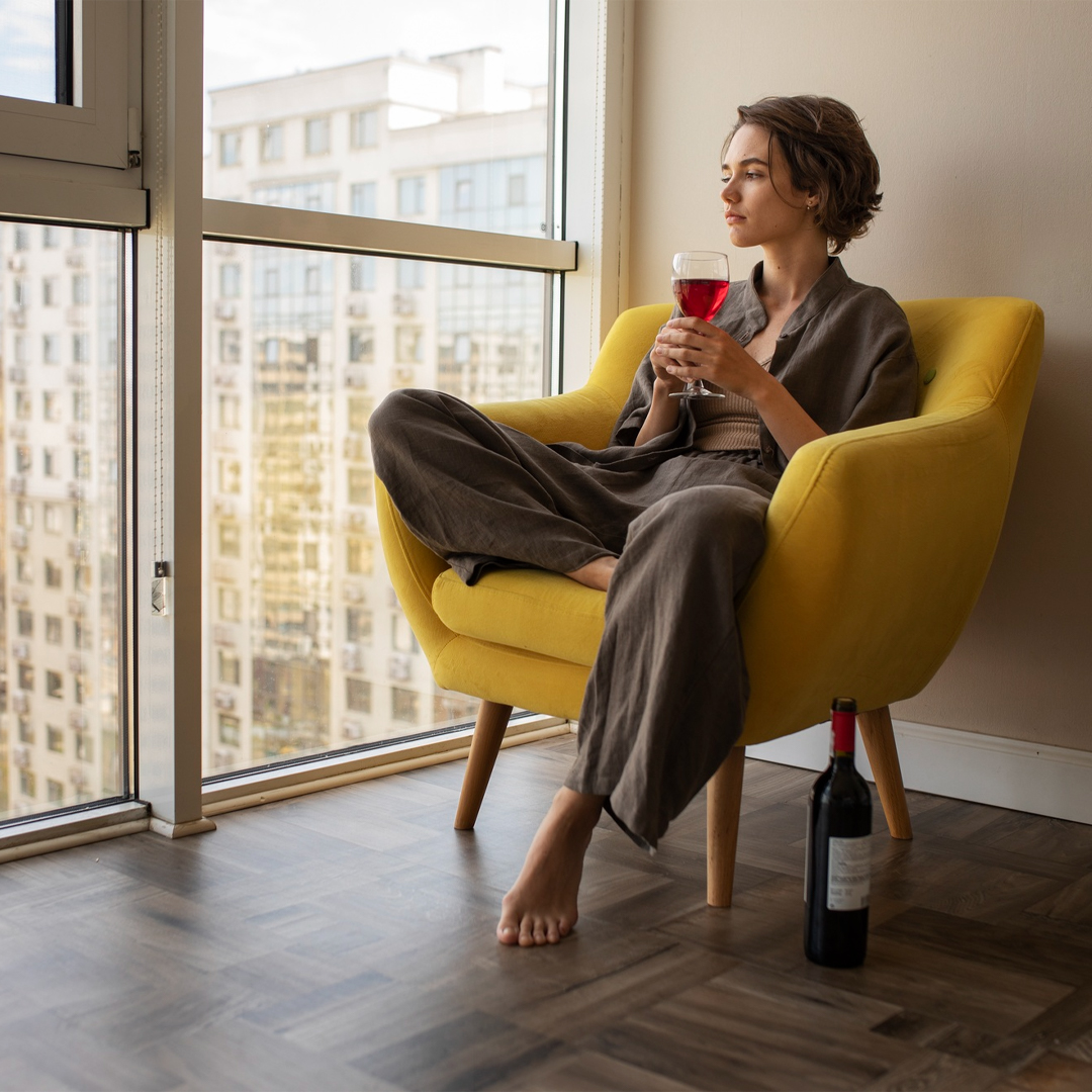 Girl sitting on sofa with Tea Cup in her Hand - Super Tramp trampolines